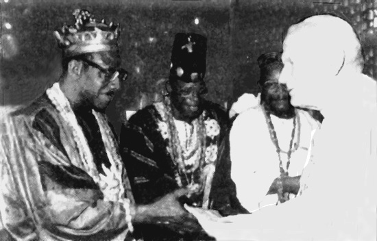 John Paul II greeting two voodoo witchdoctors